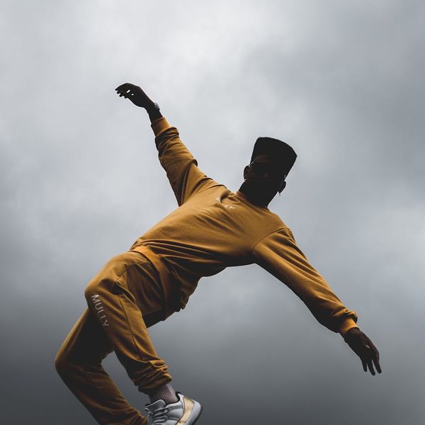 Dynamic silhouette of a person performing a squat movement.